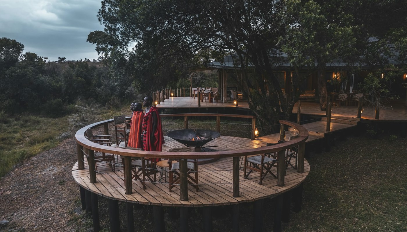 Circular firepit deck beside the river at Entim Mara Camp