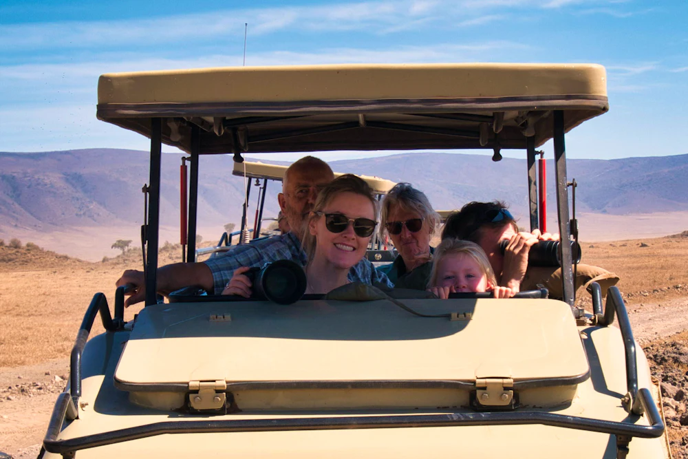 A smiling family on a game drive in the Ngorongoro Crater, Tanzania