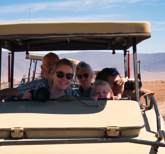 A smiling family on a game drive in the Ngorongoro Crater, Tanzania