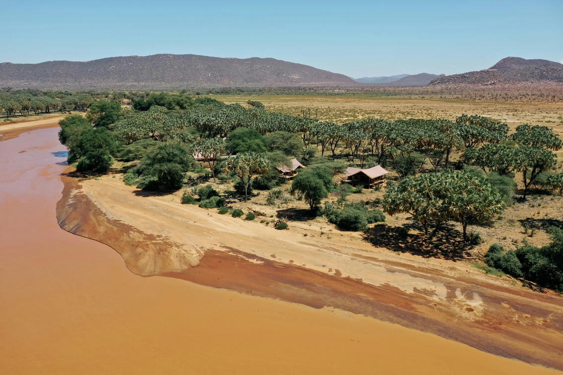 Aerial view of the riverside camp at Elephant Bedroom Camp