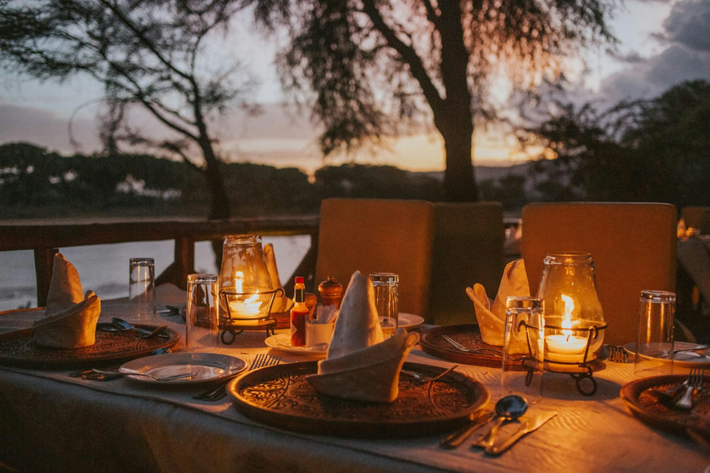 Lantern-lit table set for dinner at Elephant Bedroom Camp