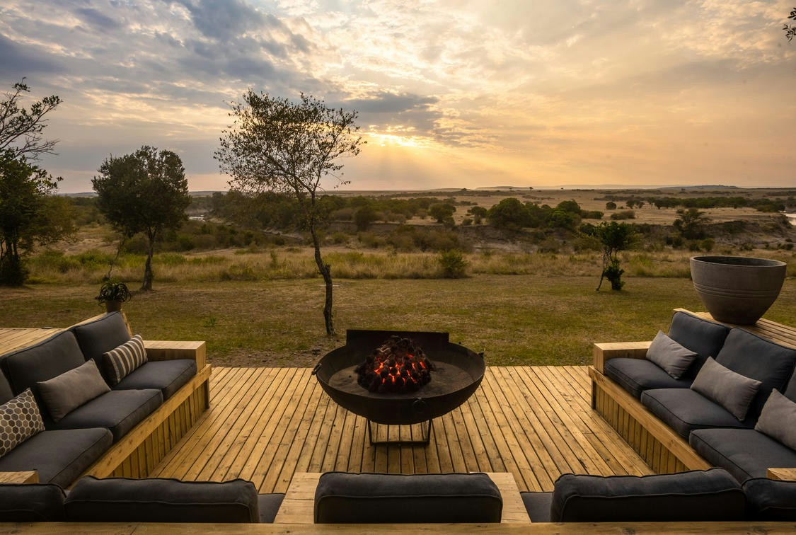 Firepit and seating on an elevated deck at Entim Mara Camp