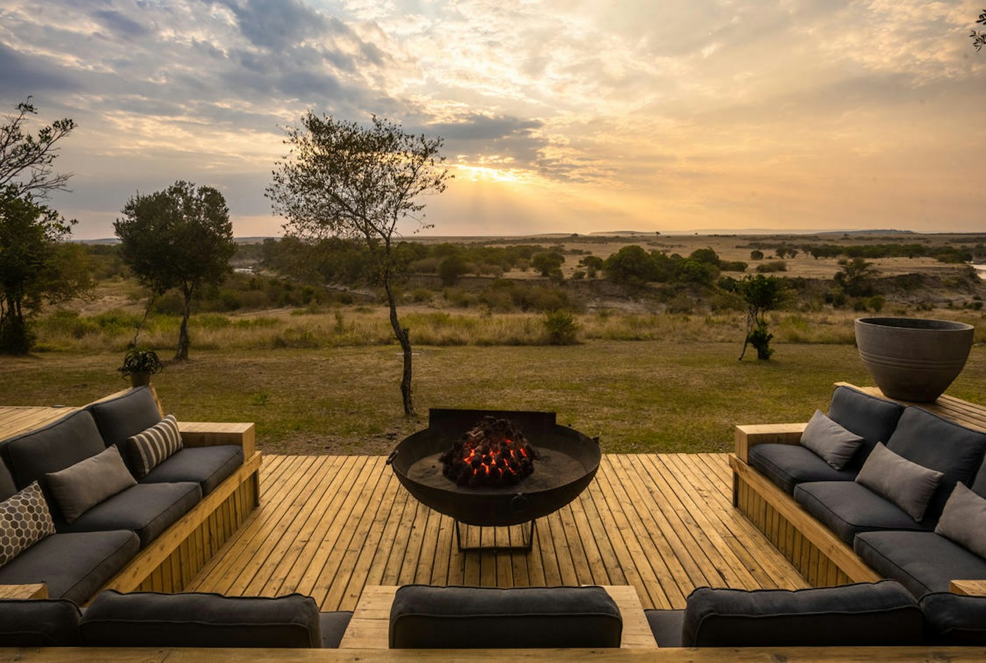 Firepit and seating on an elevated deck at Entim Mara Camp
