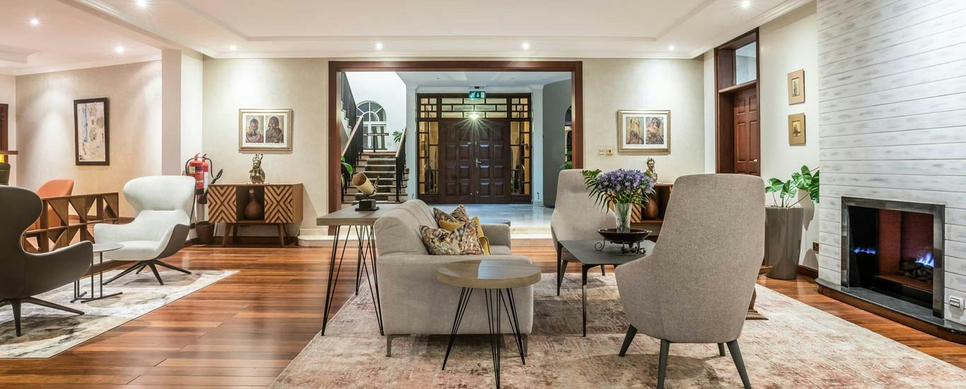 Light-filled main lounge with a fireplace at House of Waine