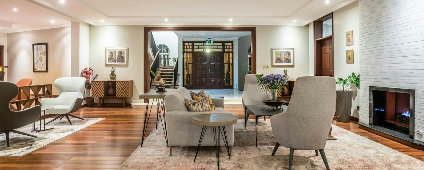 Light-filled main lounge with a fireplace at House of Waine