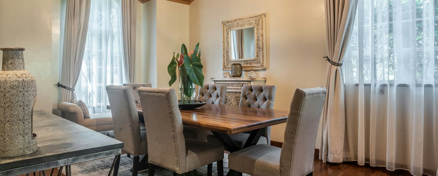 Dining room with upholstered chairs at House of Waine