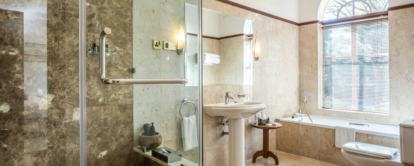 Guest bathroom with a bath and shower at House of Waine