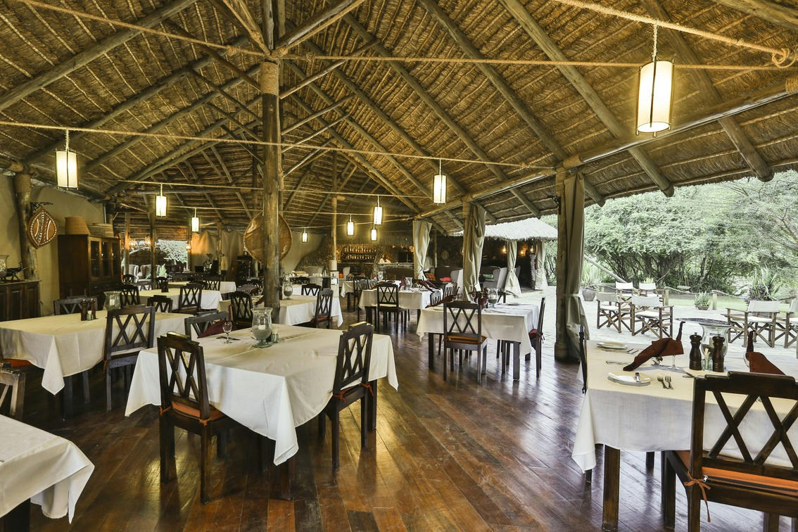 Open-sided restaurant and dining tables at Karen Blixen Camp