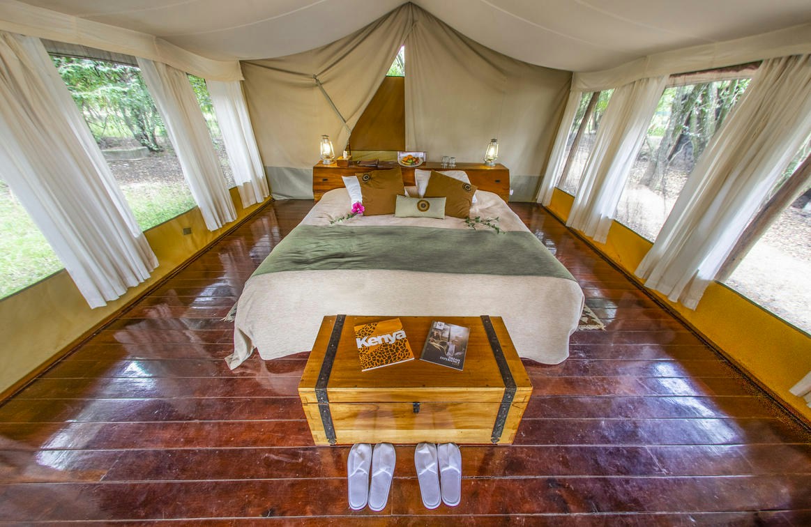 Double bed inside a canvas guest tent at Karen Blixen Camp