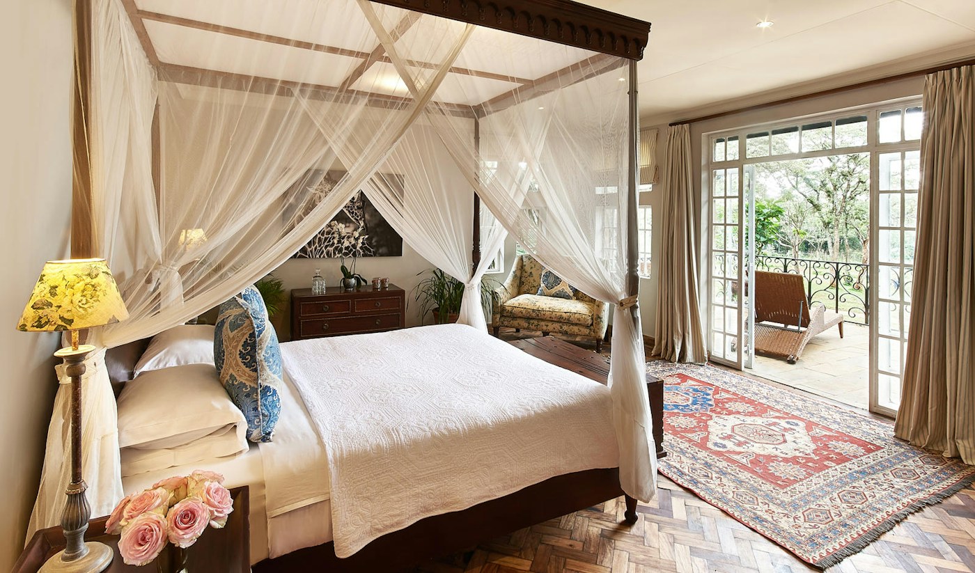 Four-poster bed in the Karen Blixen Suite at Giraffe Manor