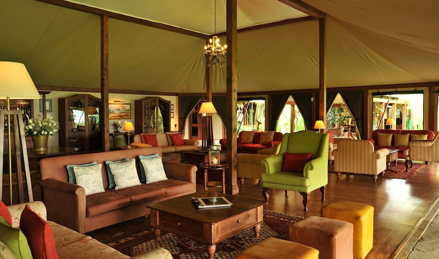 Main lounge with colourful armchairs at Lake Elmenteita Serena Camp