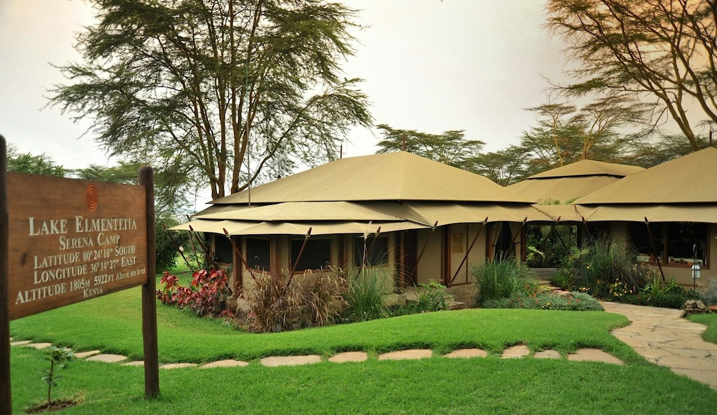 Tent exterior and camp entrance sign at Lake Elmenteita Serena Camp