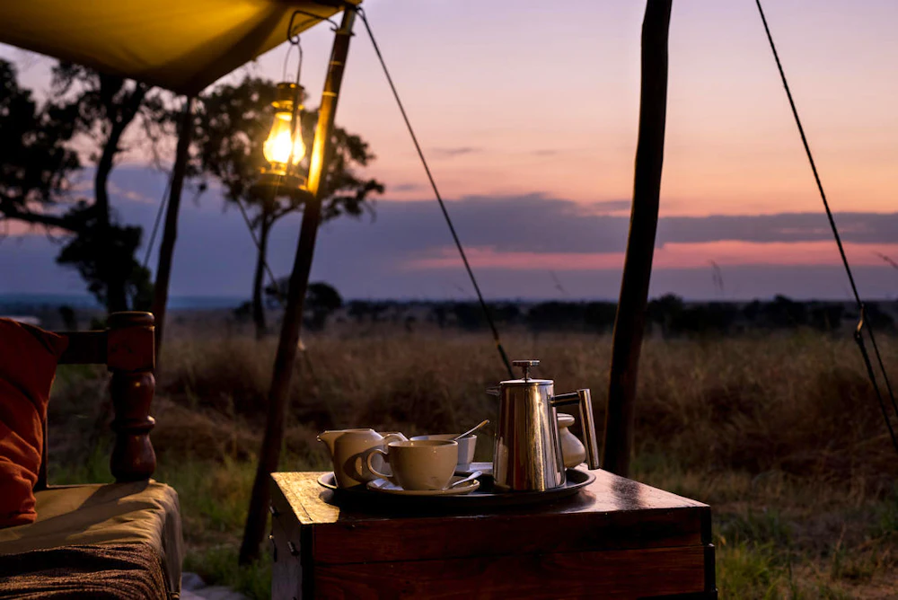 Coffee on a camp side table at dusk overlooking the Serengeti, Tanzania