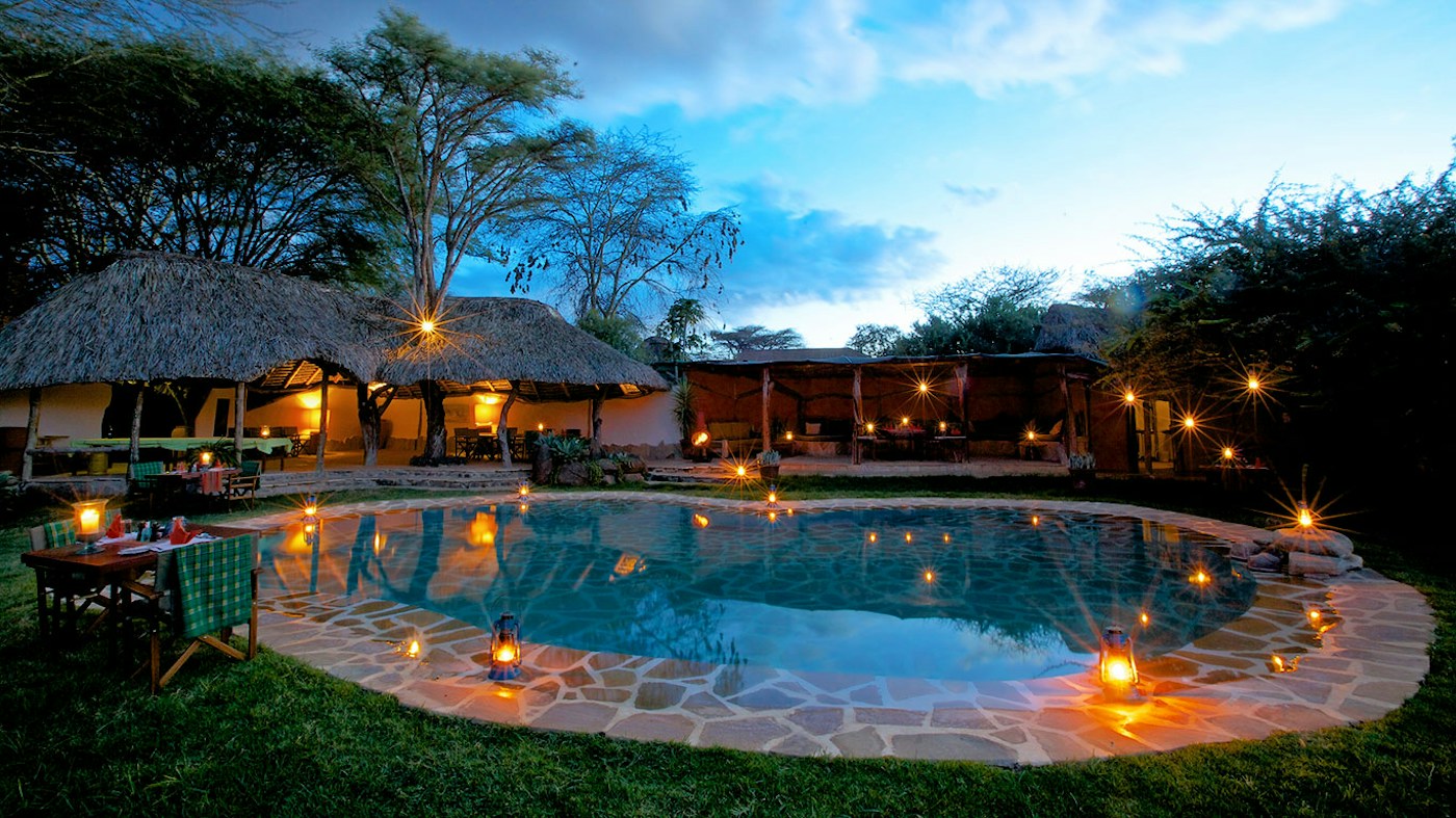 Swimming pool and main camp at dusk at Lewa Safari Camp