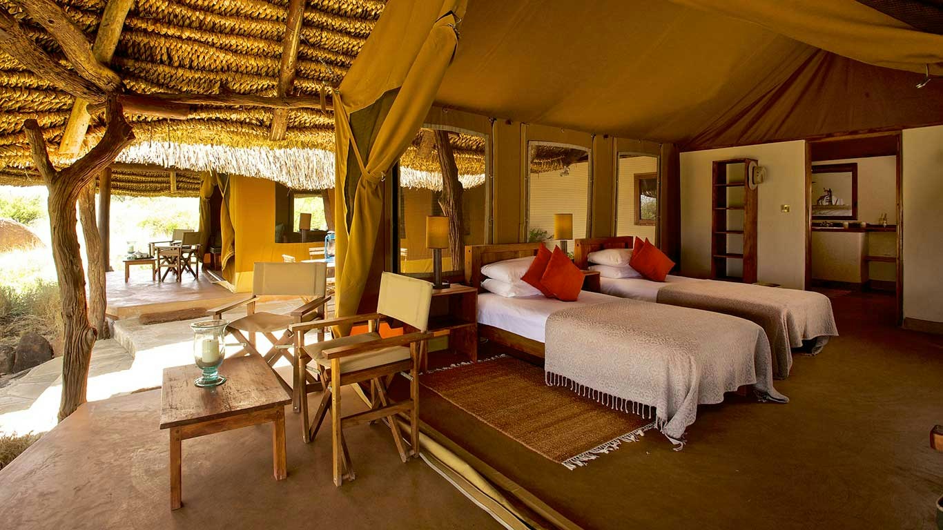 Twin beds inside a spacious guest tent at Lewa Safari Camp