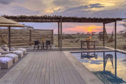 Sun sets over the pool at Namiri Plains, Serengeti