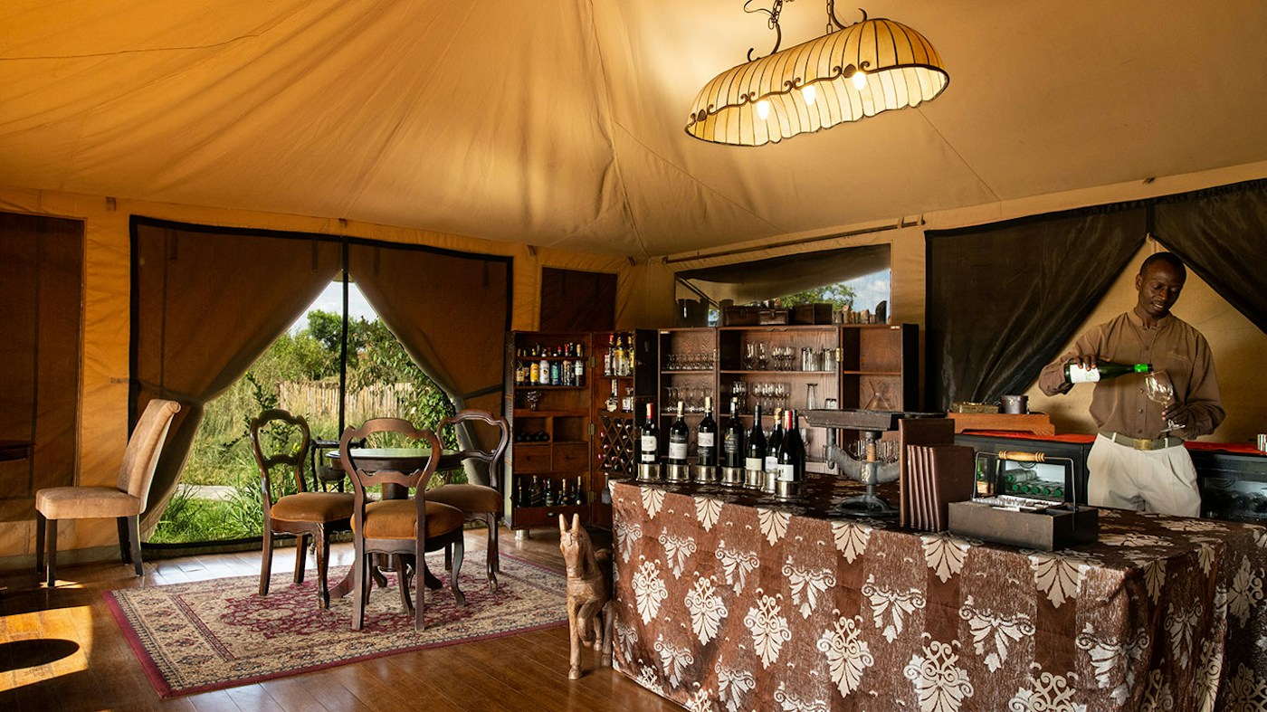Main tent bar and its open-sided seating area at Sand River Mara