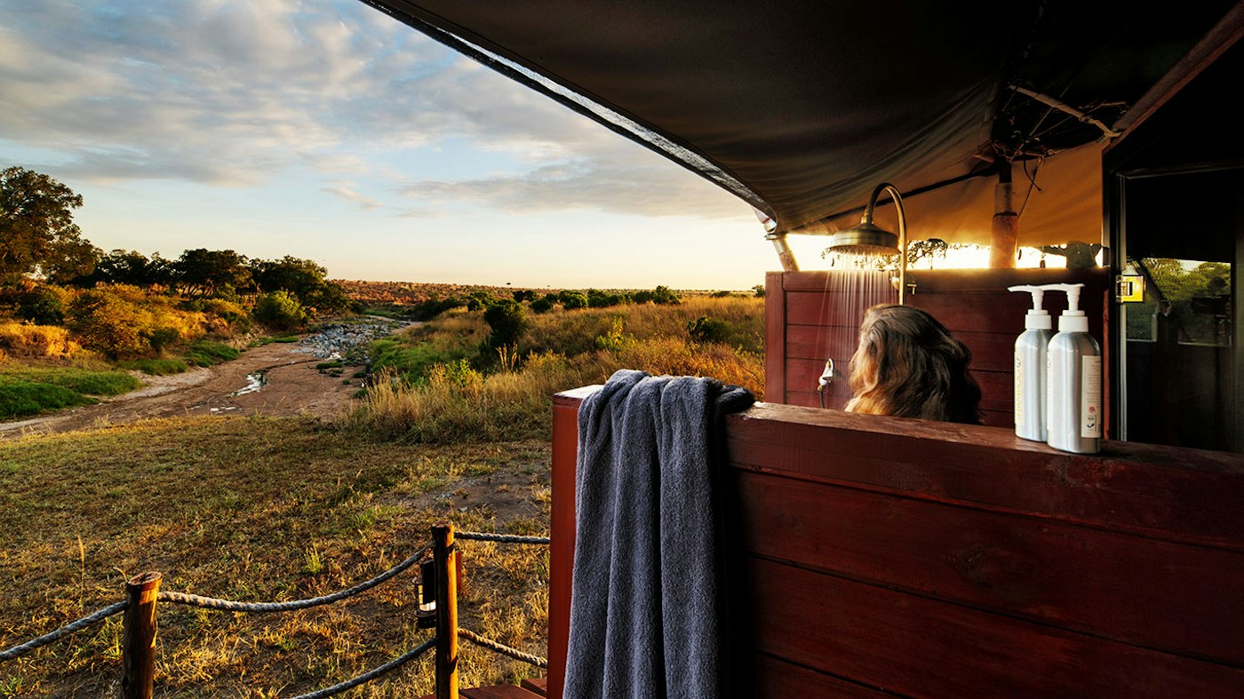 Open-air bath overlooking the bush at Sand River Mara