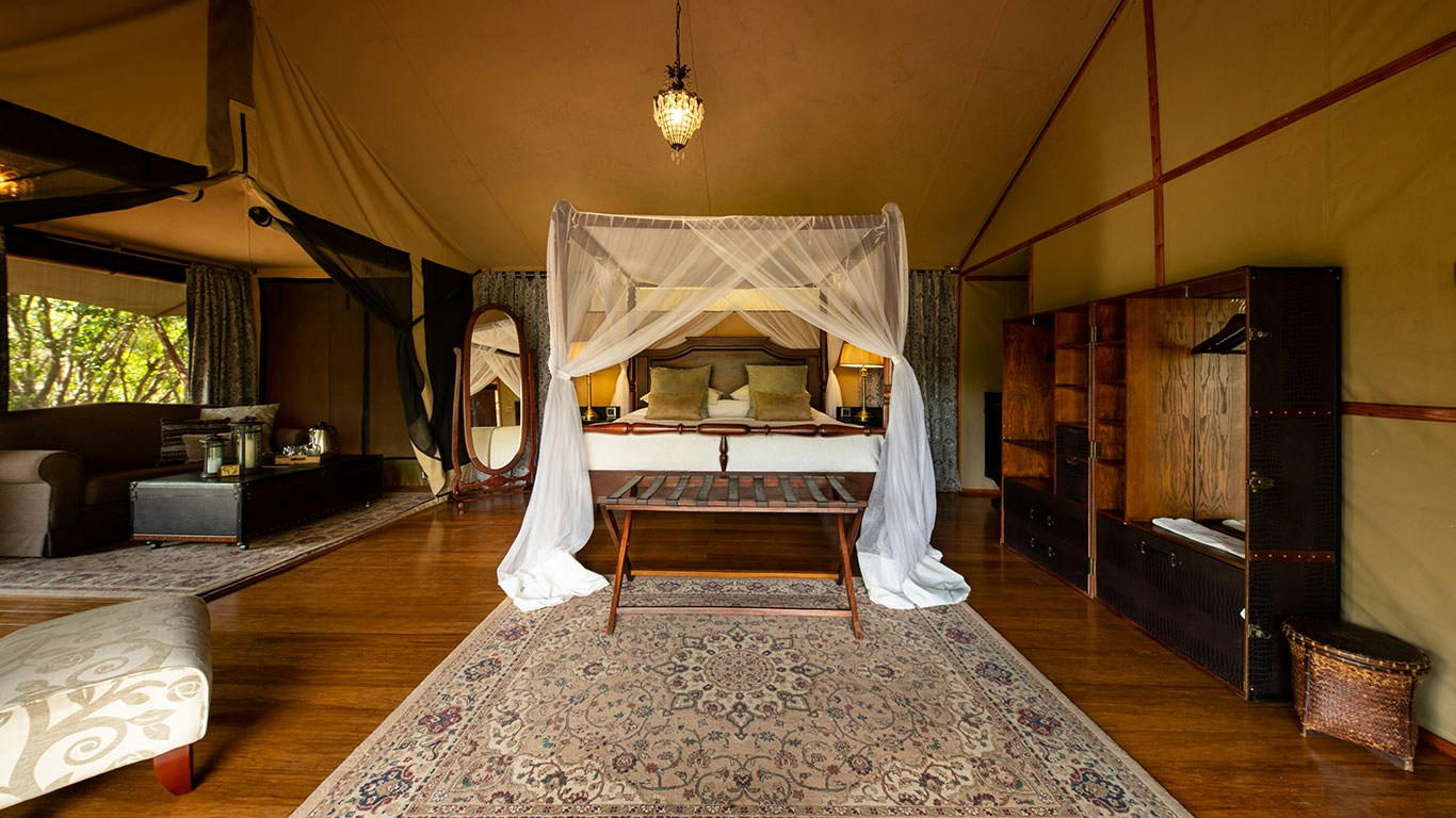 Double guest tent with a four-poster bed at Sand River Mara