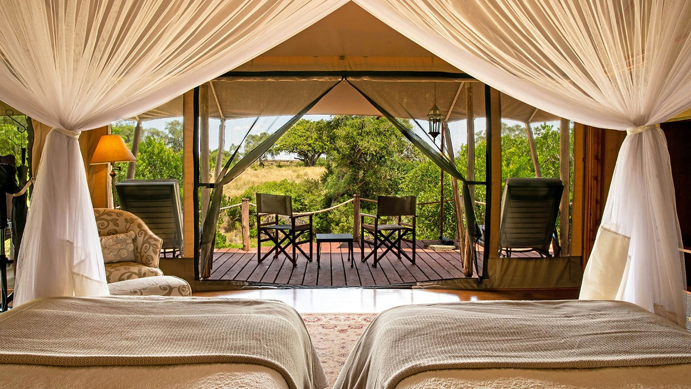 Twin guest tent opening onto a private veranda at Sand River Mara