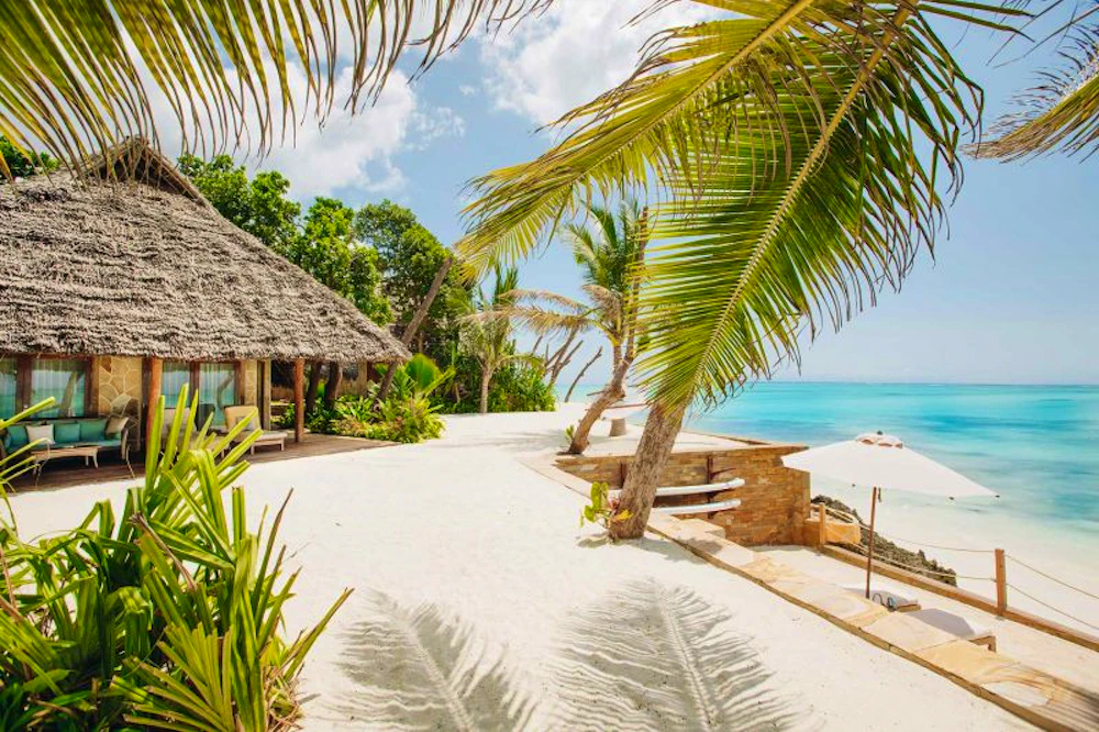 White sand, palms and turquoise water at a luxury resort on Zanzibar, Tanzania